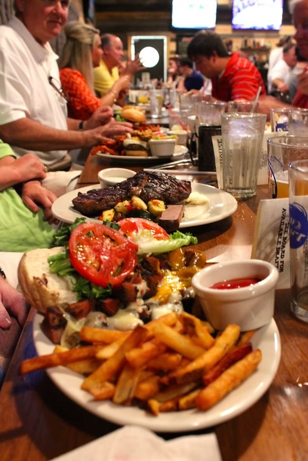 Ribeye, loaded sandwich, and fries spread at Warehouse 3Nineteen
